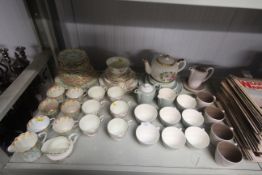 A collection of Poole pottery twin tone tea ware,