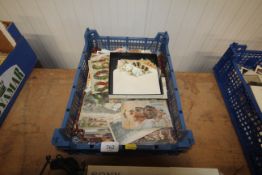 A box containing vintage postcards and ephemera