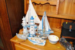 A collection of model boats and two lighthouses