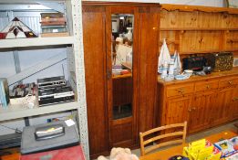 An oak mirror door wardrobe
