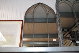 A metal arch framed mirror (68)