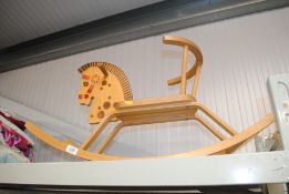 A wooden child's rocking horse