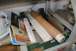 A box containing various prints, picture frames an