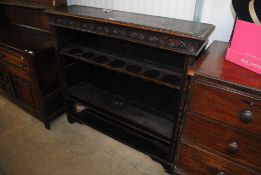 A carved oak bookcase with adjustable shelves