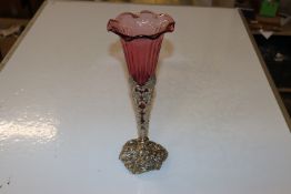 A ruby glass vase in foliate plated mount