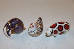 A Royal Crown Derby paperweight in the form of a p