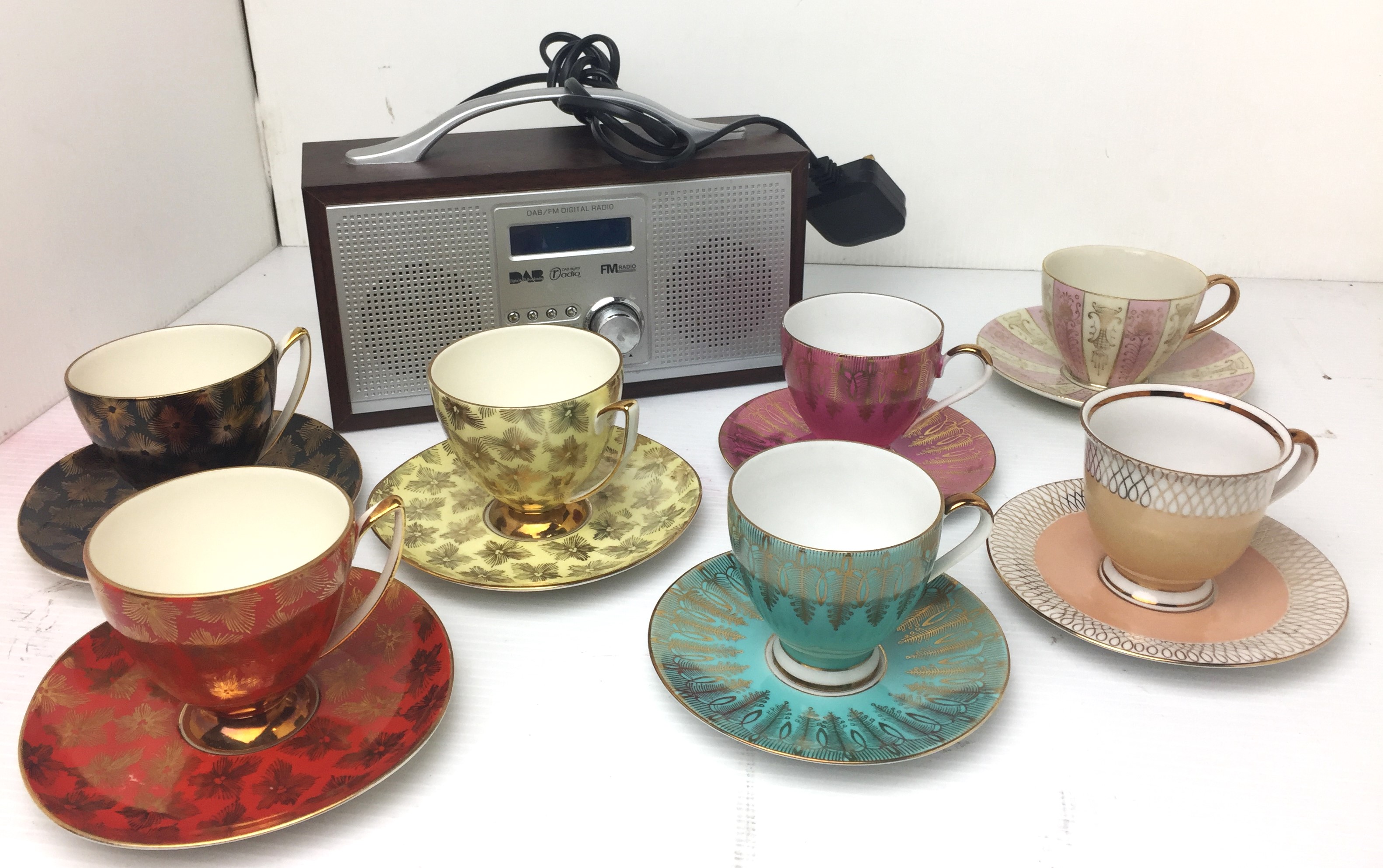 Contents to box - eight items including red-wood cased digital radio and seven cups and saucers -