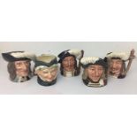 Brown plastic box containing five character jugs by Royal Doulton 9 to 11cm high including three