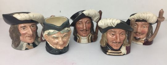 Brown plastic box containing five character jugs by Royal Doulton 9 to 11cm high including three