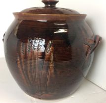 Brown glazed lidded pot with corn decoration 32cm high (repair to knob of lid) (saleroom location