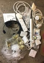 Box containing Mono wireless headset with instructions, two brass wall lights with one glass shade,