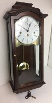 Box containing modern Kieninger pendulum wooden cased wall clock 56cm high with key (saleroom