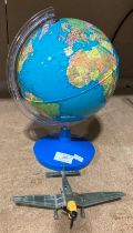 A small plastic revolving globe on stand and a Dinky Toys Junkers JU87B diecast model plane (2)