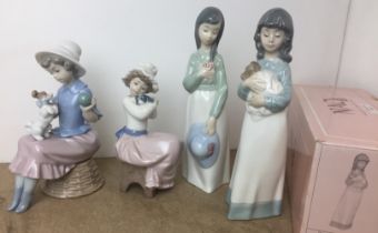 Four Lladro and Nao figurines - three girls with puppy dogs and another 17 to 23cm high - one with