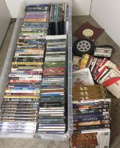 Plastic box containing one hundred and seventy DVDs, CDs,