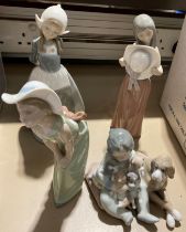 Four unboxed Lladro figurines 'Girl with Puppies',