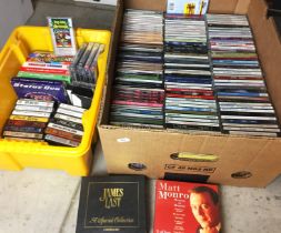 Two boxes containing one hundred and sixty CDs and thirty cassette tapes, easy listening,