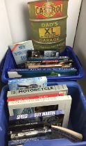 Two blue plastic boxes containing twenty-five books and DVDs - motor cycles, cars, railway,