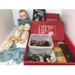 Red box containing eleven items including three vintage dolls by Pedigree 24 and 38cm tall,