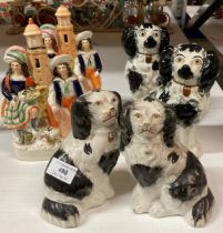 Two pairs of Staffordshire style spaniels and two Staffordshire style flat back figures (damaged)