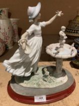 A Lladro porcelain group of young girls with birds round a bird bath on wood plinth (saleroom