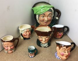Seven character jugs - two by Royal Doulton - Sairey Gamp (16cm high) and Old Charlie (9cm high),
