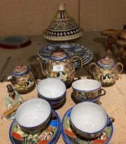 A fifteen piece oriental patterned porcelain tea service, a colourful pottery dish with cover,