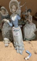 Three unboxed Lladro ladies 'Reading', 'Sewing' (broken finger) and 'Promenading' (with broken arm,