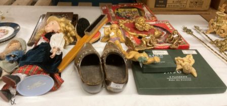 Contents to part table top - two dolls, pair wood clogs, gilt and other cherub ornaments,
