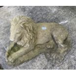 Large concrete garden ornament of a recumbent lion,
