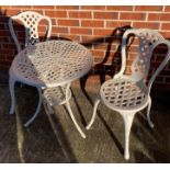 A white painted metal circular patio table (60cm diameter) and two matching chairs (saleroom