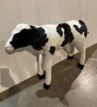 Black and white calf stuffed toy by DPL Leeds Ltd,