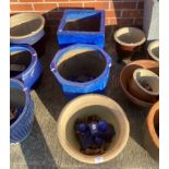 Three large blue glazed planters complete with a quantity of blue glazed pot stands (saleroom