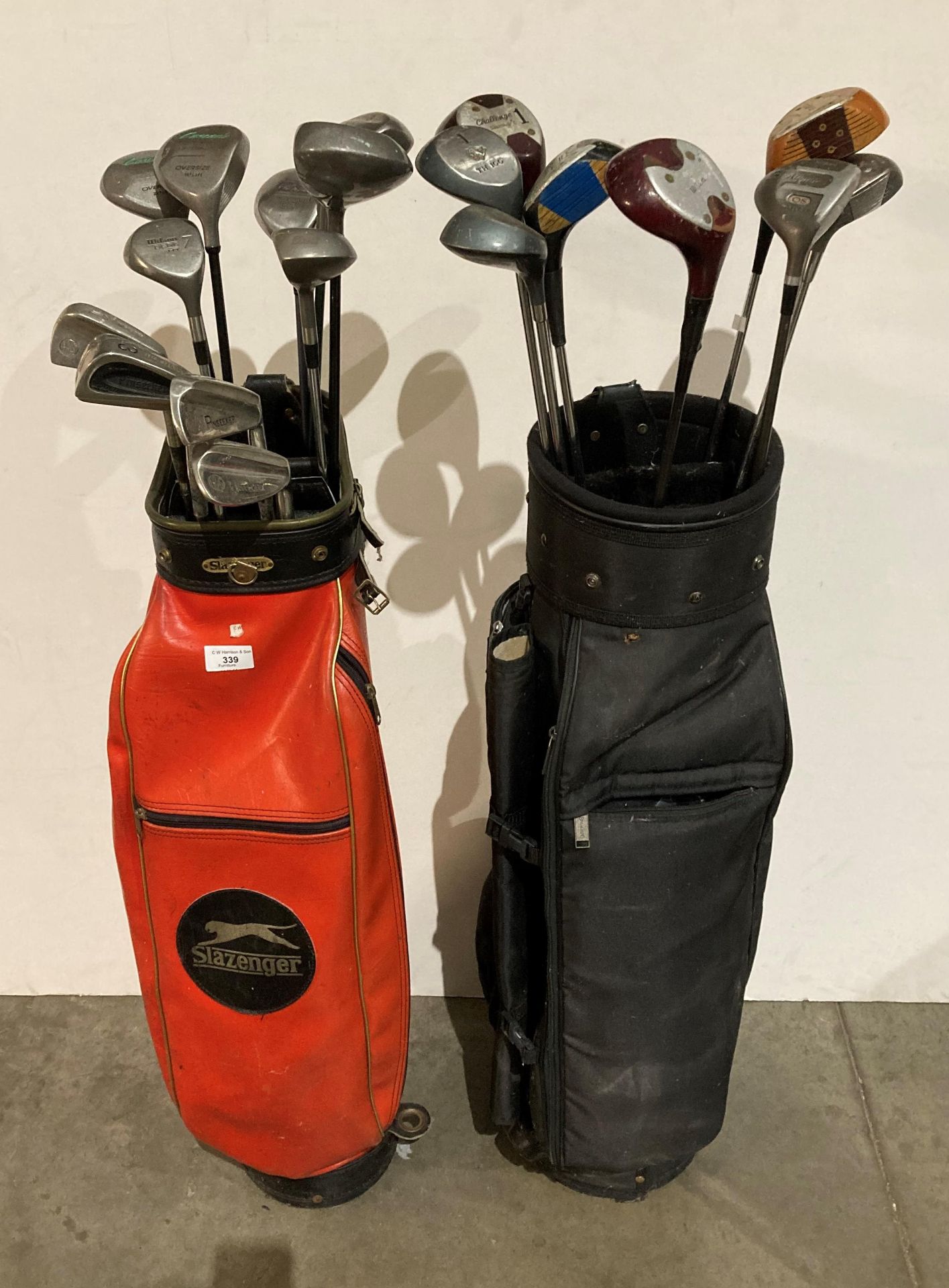 Twenty assorted golf clubs in two golf bags Wilson, Ben Sayers, Cobra