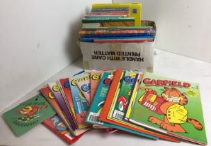 Box containing fifty plus items including Garfield related books, annuals,