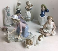Box containing eight Lladro Nao figurines including 'Girl with Lamb', 'Ballerina', 'Girl with Dog',