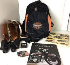 Box containing six items including Harley Davidson belt buckle, parts and accessories catalogue,