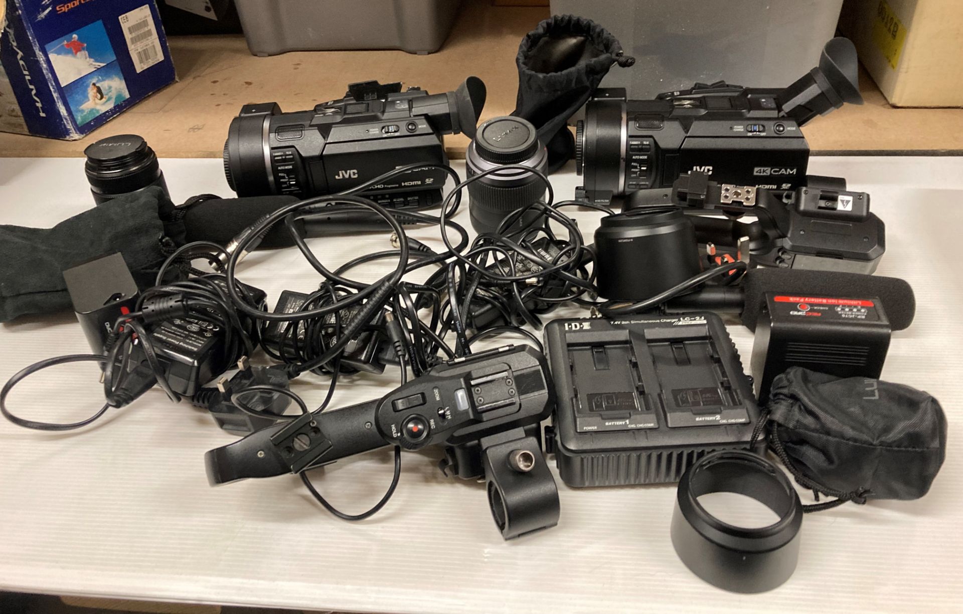 2 x JVC AVCHD 4K hand-held video cameras complete with Lumix lenses, spare batteries, microphones,