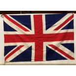 Union Jack flag with wooden pegs to two corners,