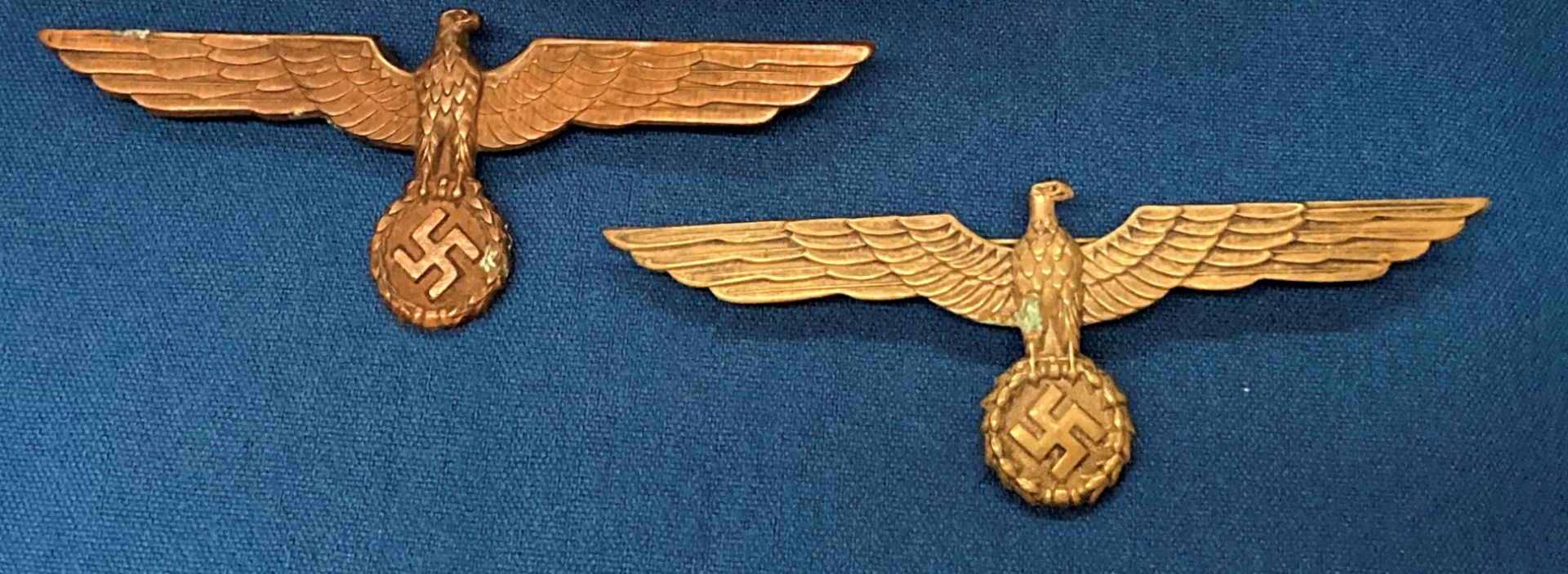 Two Nazi Party brass badges (Saleroom location: S3 GC1)