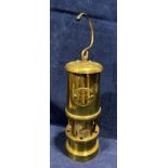 A small brass model miner's lamp with name plate Hockney Lamp and Limelight Company,