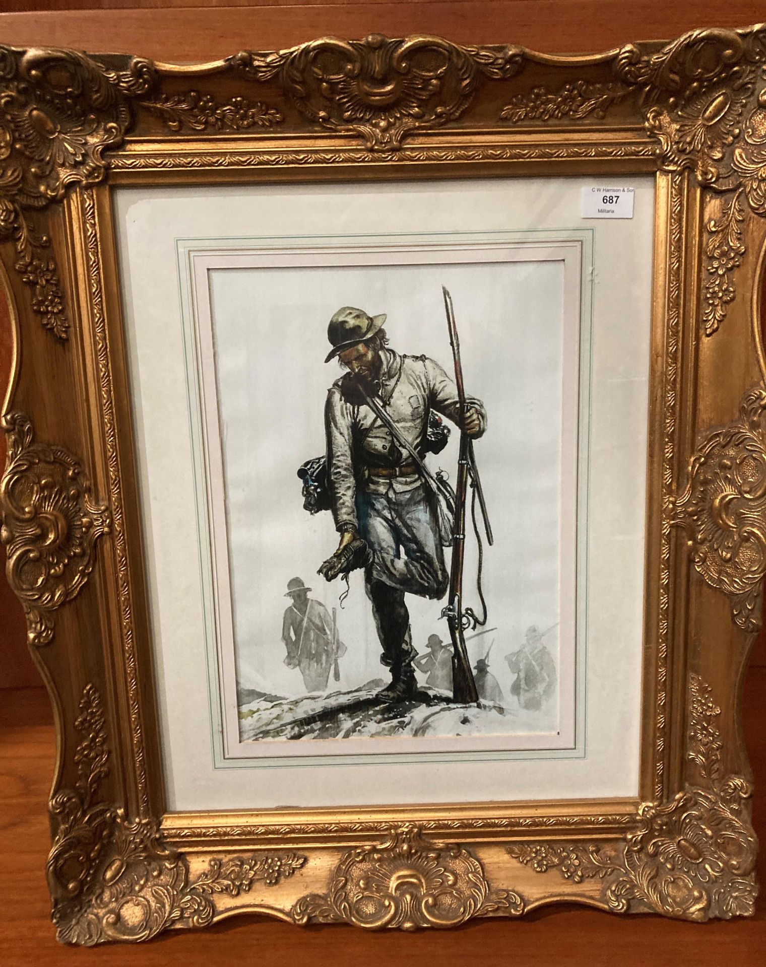 An ornate gilt framed print of a Confederate musket man,