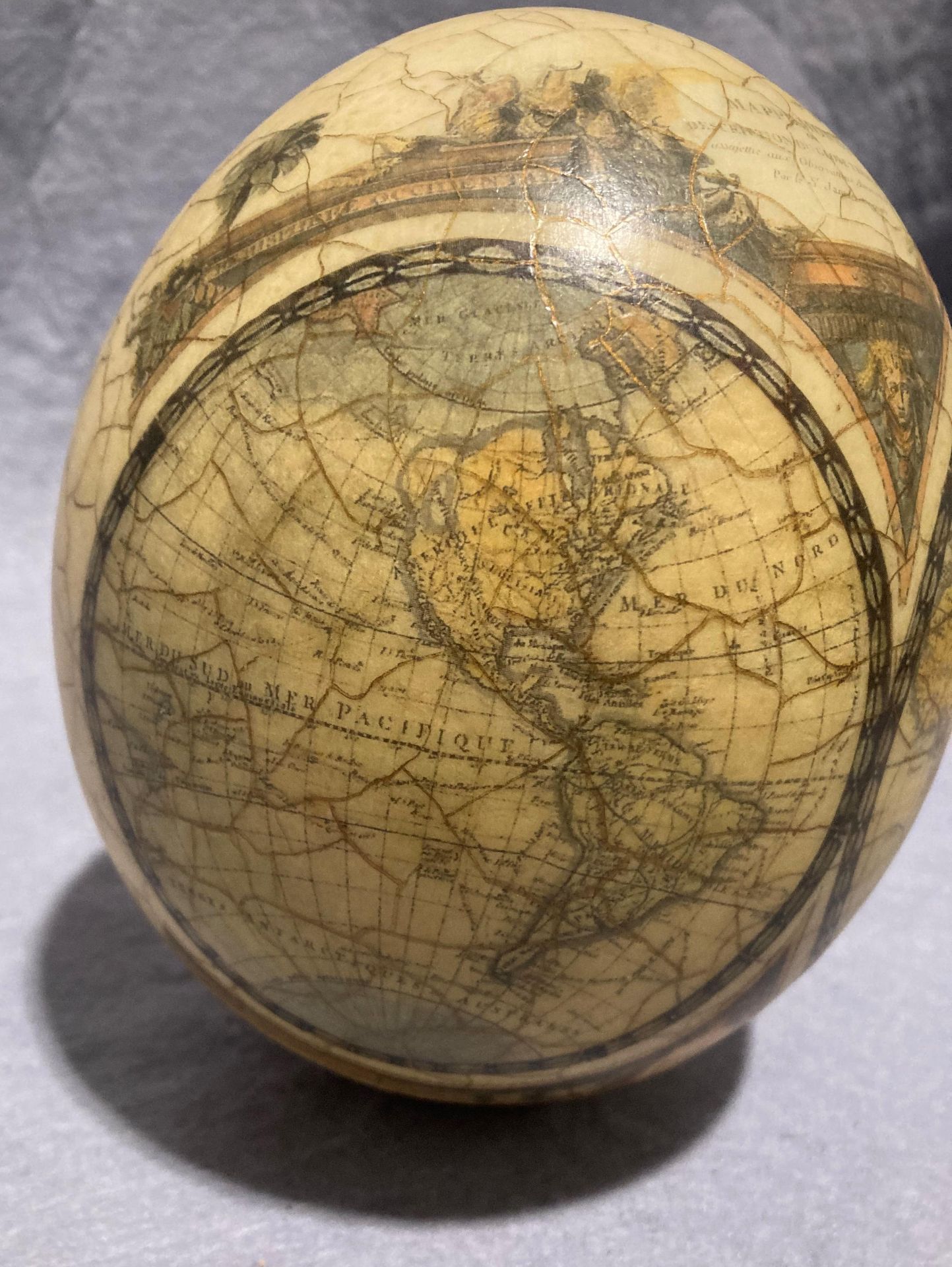 A decorated ostrich egg with World Map and Africa animal scene (approximately 16cm high) with a - Image 2 of 11