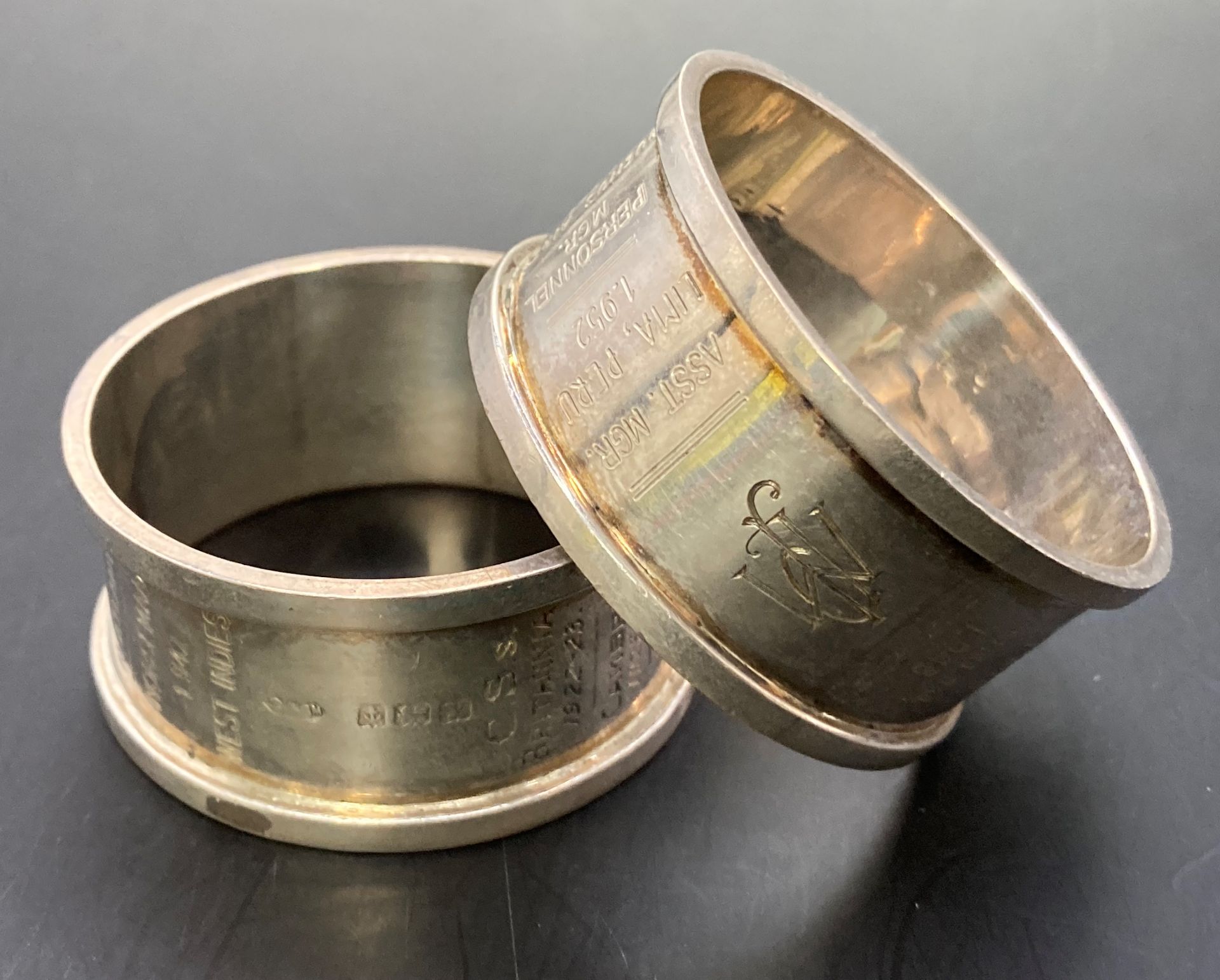 Two hallmarked silver napkin rings engraved with all postings from 1923 to retirement in 1961 and