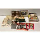 Contents to two boxes - 15 cigarette card booklets and two tins of assorted cigarette cards,