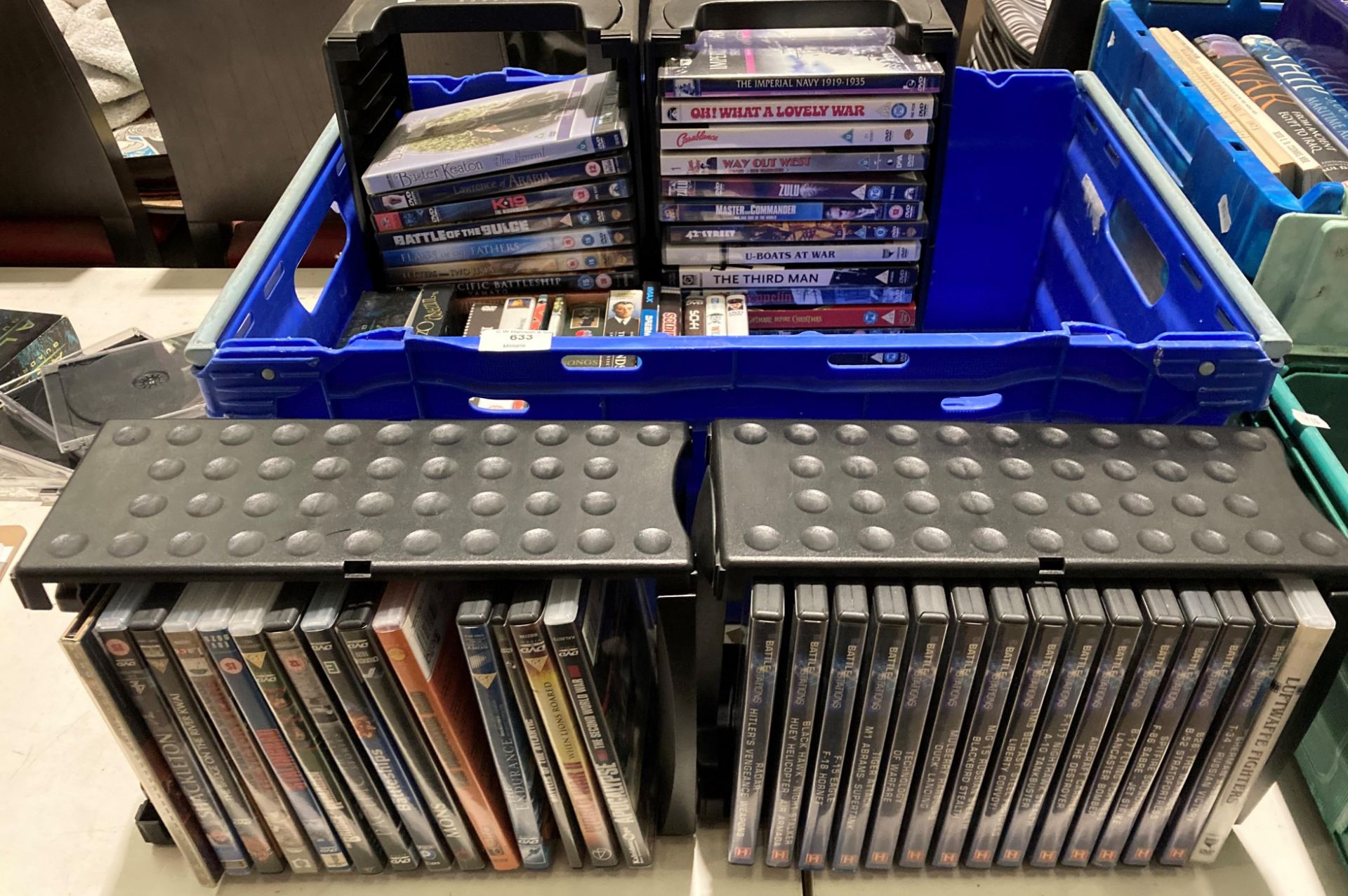 Contents to blue plastic crate - approximately 68 DVDs etc.