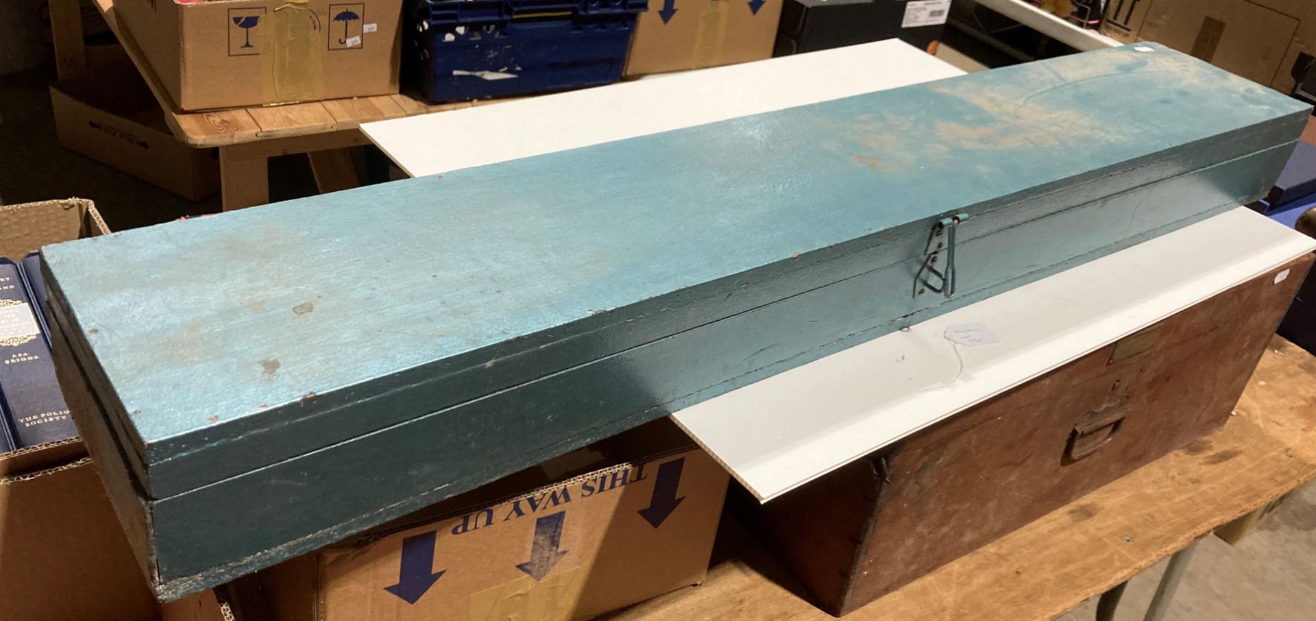 A home-made blue-painted chipboard gun-case,