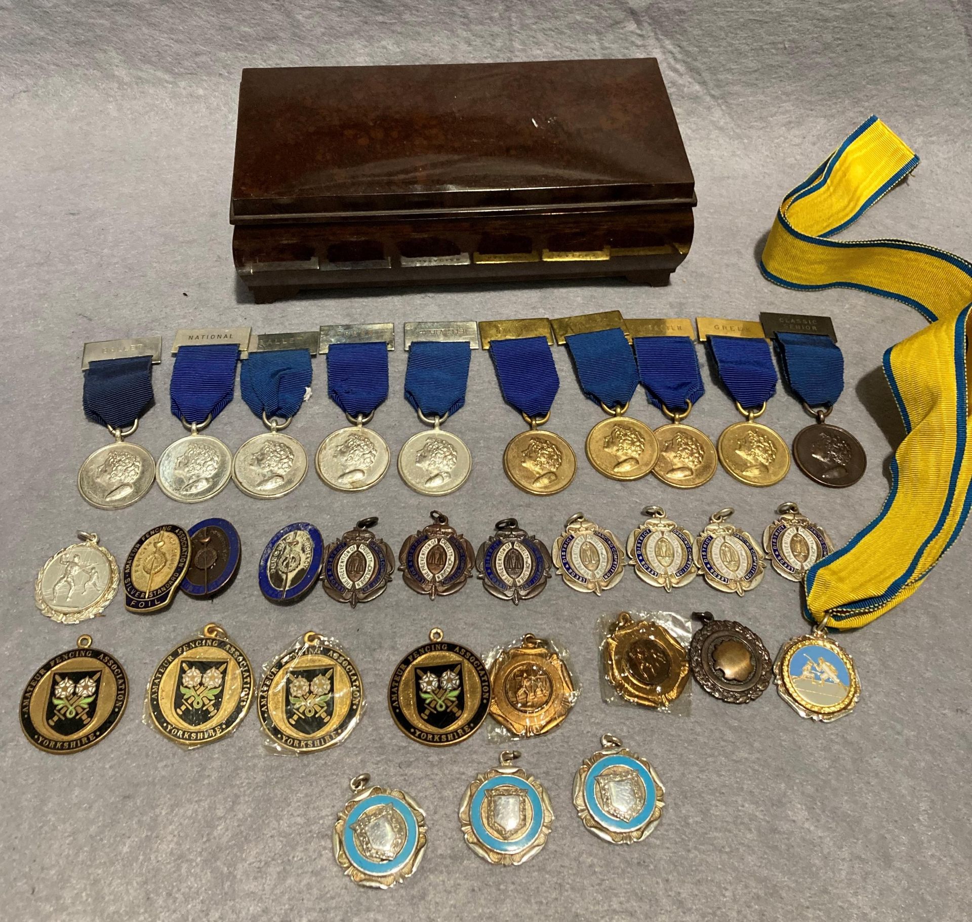 Brown Bakelite box and thirty assorted medals/awards for dancing,