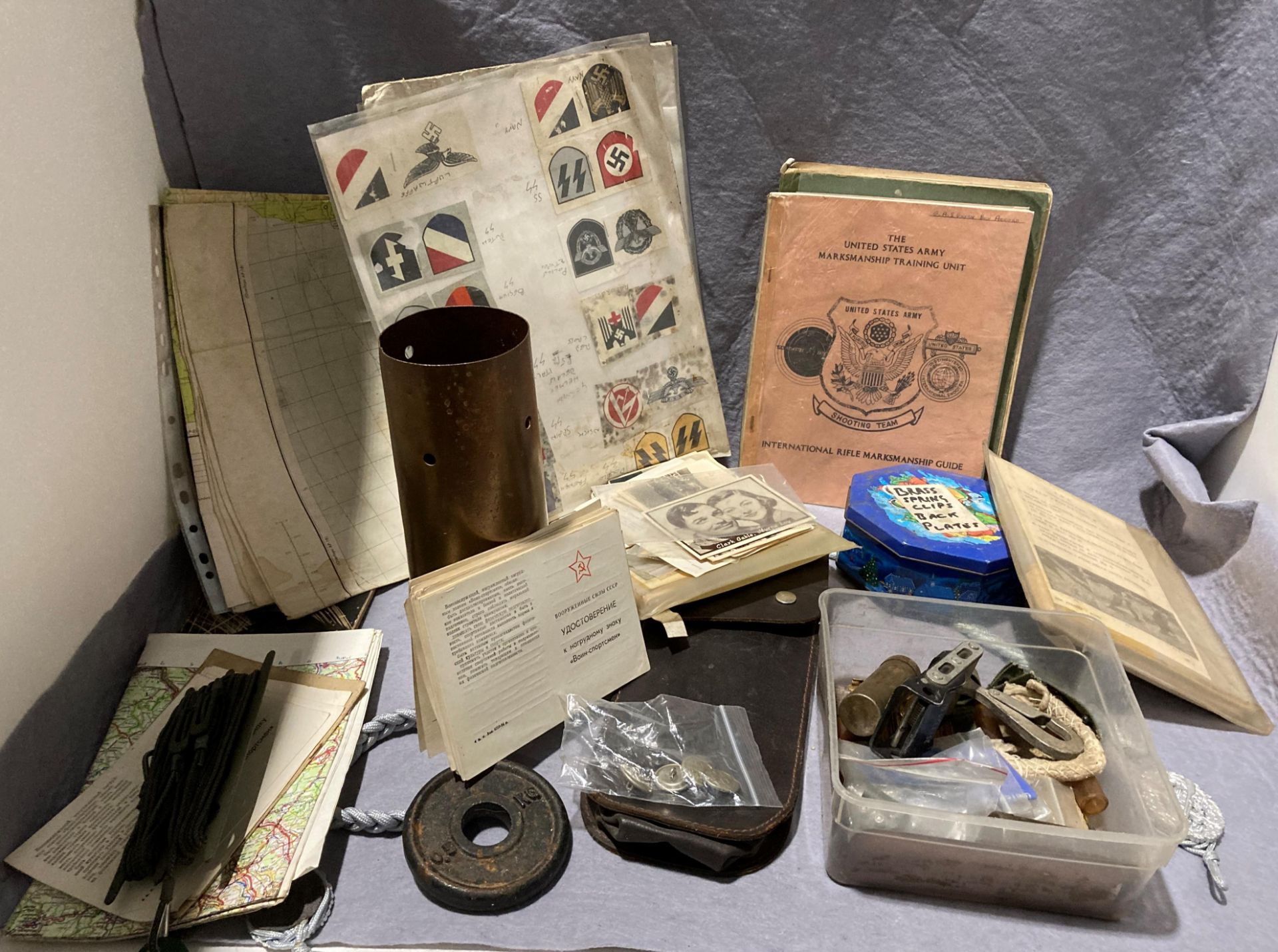 Box containing various bits of militaria including shell case, ephemera and maps, etc.