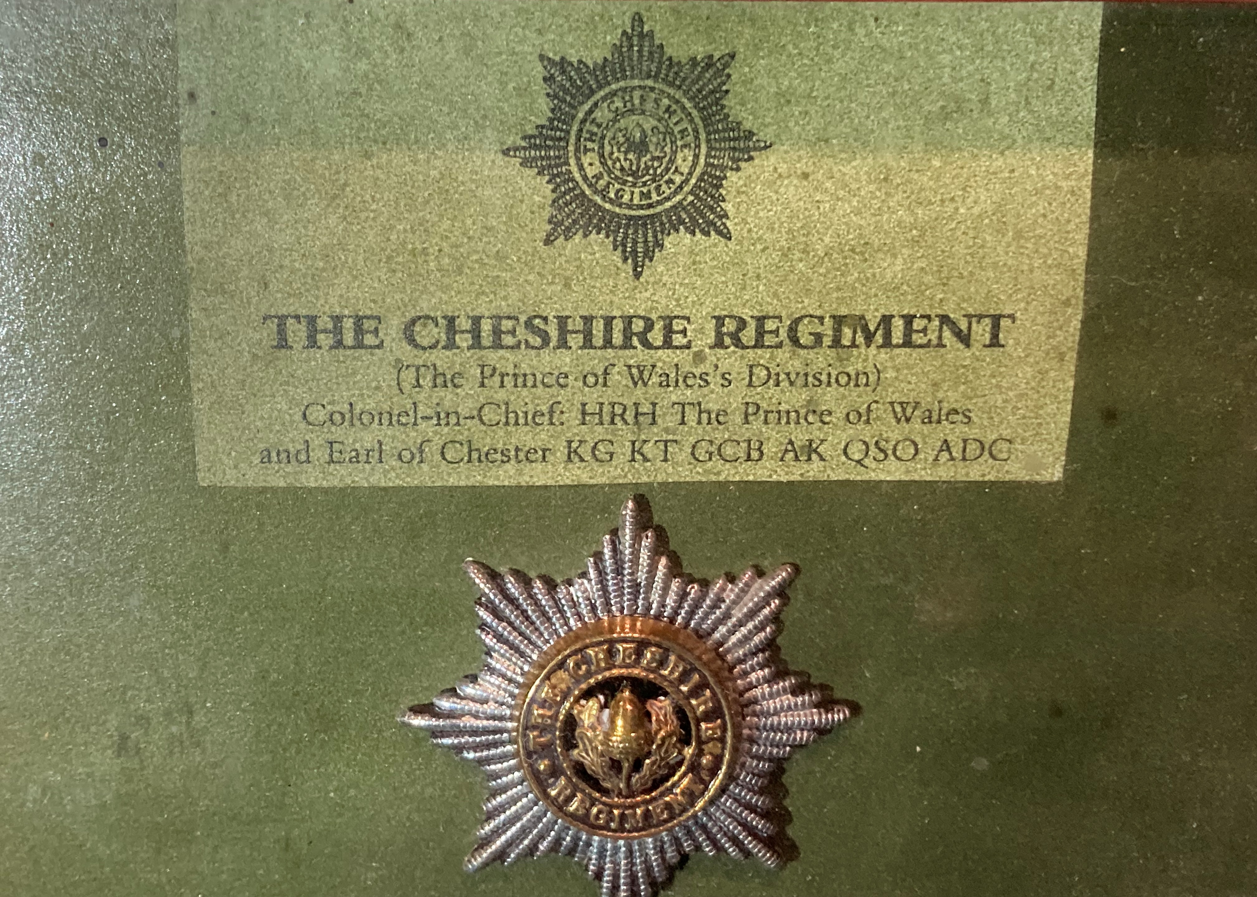 A framed display of badges and buttons for the Cheshire Regiment with a list of battle honours to - Image 2 of 3